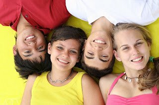 Teens laying down smiling
