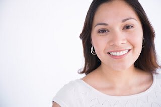 Woman wearing white smiling